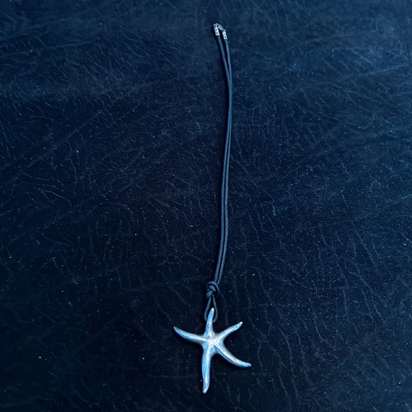 Jewelry - Sterling silver star pendent on black cord necklace.